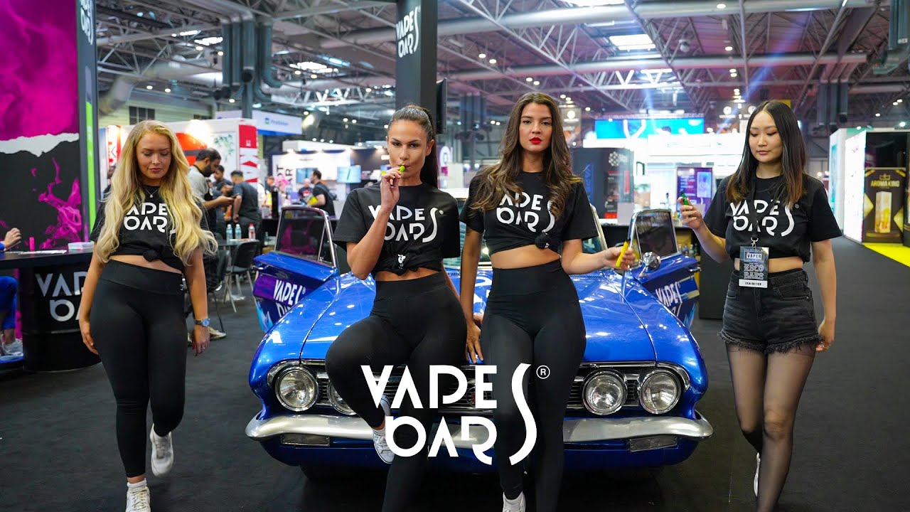 Exhibition Models Holding Vapes Bars Ghost 800 In an Expo.